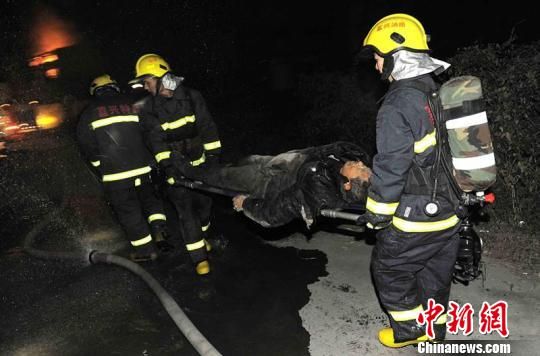 圖為消防戰士從現場救出被困者。 張羽 攝